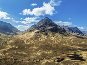 Buachaille Etive Beag and Three Sisters in Glencoe over Moors and Road A82 from a drone, Highlands,