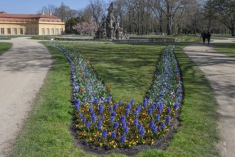 Planted spring beds in the palace park, behind the Huguenot fountain from 1706, Erlangen, Middle