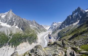Picturesque mountain landscape with imposing mountain peaks and glaciers, mountaineer on hiking