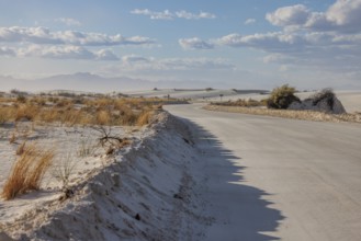 Road between sand dunes at White Sands National Park in Alamogordo, New Mexico, USA