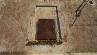 Lost Place, Locked rusty door in a weathered wall under summer light, Radio Station, WW2, Agios
