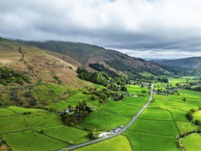 Farms and Mountains over road A591 from a drone, Grasmere Lake, Grasmere, Ambleside, Lake District,