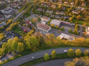Town view with residential buildings, streets and autumnal trees in an evening atmosphere, Nagold,