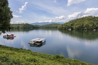 View of a house boats on Fontana Lake as seen from the open air car of the Great Smoky Mountains