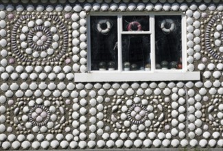 A house wall with a shell pattern and a window, artistically decorated, Hammavoe, Shetland Islands,