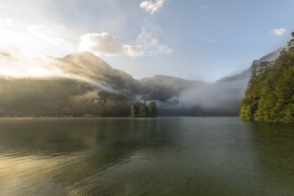 Mystical morning at Königssee in Schönau with boathouses and Christlieger. Sunrise and beautiful