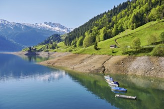 Motorboats moored at the reservoir, snow-covered Alps in the background, Lake Wägital, Canton