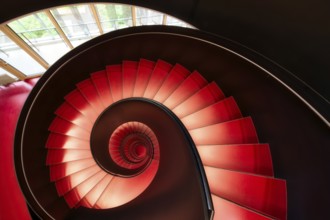 Modern red spiral staircase in an educational building, Zurich, Switzerland