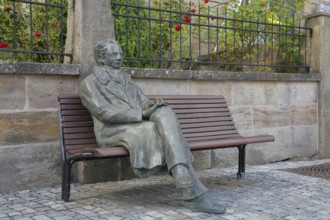 Johann Wolfgang von Goethe by Klaus Gutting sitting on the bench, bronze sculpture, looking, arms,