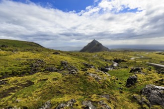 Barren moss-covered volcanic landscape, cone-shaped mountain Stapafell, rain clouds, changeable