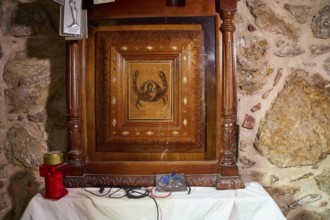 Legend, crab, shell fisherman, wood carving with crab motif in a chapel on an altar with candle,