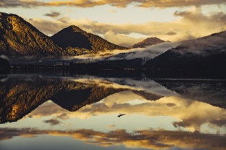 Sunrise with reflections and alpenglow in Lake Heiterwanger See in Tyrol in the Alps in Austria