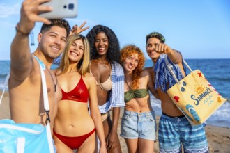 Group of cheerful multi ethnic friends taking a selfie on the beach, enjoying summer holidays