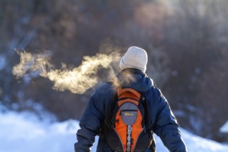 Person walking in very cold weather, Visual effect of the steam seen when exhaling in cold weather.