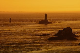 Phare de la Vieille lighthouse at sunset, Pointe du Raz, Cap Sizun, Finistere department, Brittany,