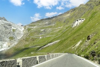 View of east ramp ascent to descent from Alpine pass Stelvio Stilfserjoch mountain road above tree