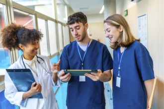 Doctors and nurses reviewing medical records on a tablet, collaborating on patient care in a