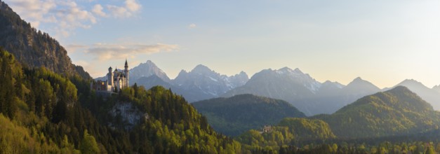 Wide panoramic landscape with castle and alpine background, Neuschwanstein, Schwangau near Füssen,