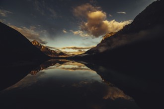 Sunrise with reflections in Lake Heiterwanger See in Tyrol in the Alps in Austria