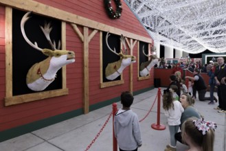 Children listen to animatronic reindeer inside the Barksdale Pavilion during the Harbor Lights