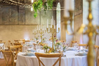 Elegant and romantic wedding tables with candles and natural decoration, event and wedding location