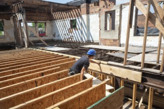 Detroit, Michigan - Austin Barr helps rehab a long-vacant and crumbling commercial building in the
