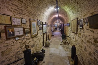Long tunnel room with paintings and exhibits on the walls, War Museum, Military Museum, Tunnel