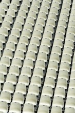 Empty stadium seats arranged in neat rows highlight the readiness for an upcoming sports event or