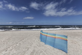 Deserted Baltic Sea beach with a single windbreak, blue sky, Kühlungsborn, Baltic Sea,