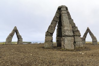 Gravel path to the Arctic Henge, large stone gates, basalt, landmark, in barren landscape,