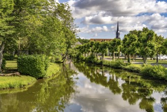 The river Loir and Notre-Dame church in Alluyes, Centre-Val de Loire, France
