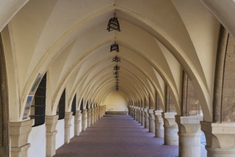 Long covered portico with arches and patterned floor, harbour area, Rhodes Town, Rhodes,