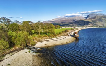 View of Corpach Wreck or Old Boat of Caol and Nevis Range Mountains from a drone, Caol Beach,