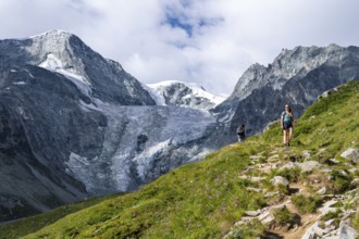 Mountaineer on a hiking trail, mountain landscape near Arolla, in the background mountain peak Mont