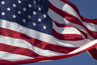 American flag waving in the wind against deep blue sky