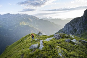 Mountaineers in a picturesque mountain landscape in the atmospheric evening light, view from the