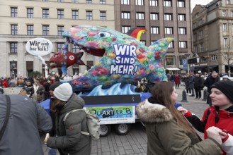 Demonstration against right-wing extremism with motto car We are more, Big fish eats small fish,