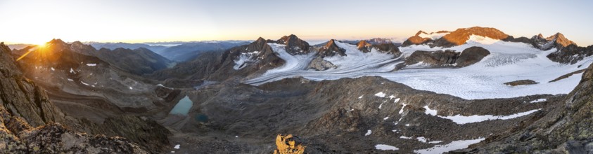 Panorama at sunrise with alpenglow, high mountain landscape, view of blue glacial lakes, mountain