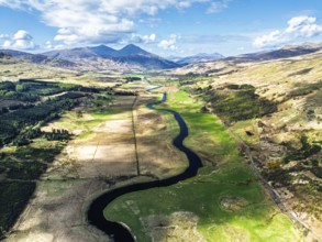 Farms and Mountains over River Dochart and Road A85 from a drone, Perthshire, Scotland, UK