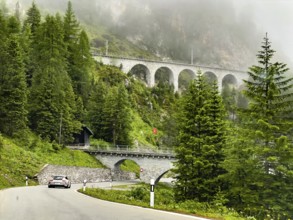 View of front Albula road Veja Alvra from Albula Pass towards Bergün with viaduct for railway in