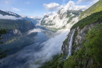 Gjerdefossen waterfall, at Ørnesvingen viewpoint, atmospheric clouds over the fjord in the morning
