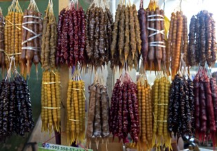 Traditional Georgian sweets Churchkhela made from walnuts and thickened grape juice, market stall