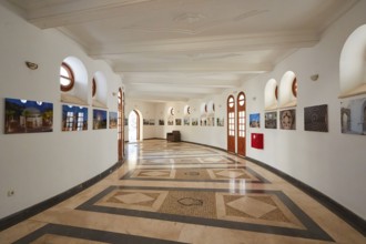 Elegant exhibition room with circular mosaic and photography on the curved wall, Kalithea,