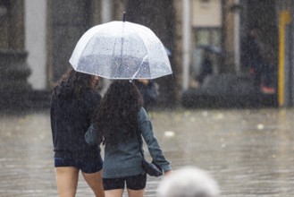Rainy weather in Stuttgart. People with umbrellas hurry through the rain on Königstraße. Stuttgart,