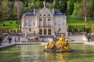 Water parterre with flora fountain and the portal of Linderhof Castle in spring, municipality of