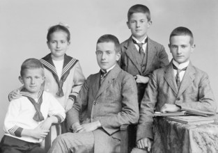 Group photo of five siblings, 1930s, Four boys and a girl in traditional suits and dresses pose