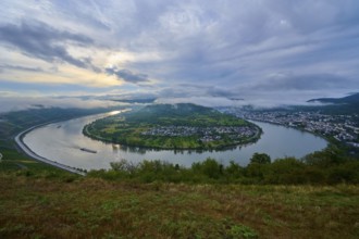 River bend at dusk with passing cargo ship and soft clouds in the sky, summer, Rhine bend Boppard,