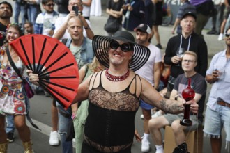 Man in net outfit with fan at the 47th Christopher Street Day under the motto Never again silent in