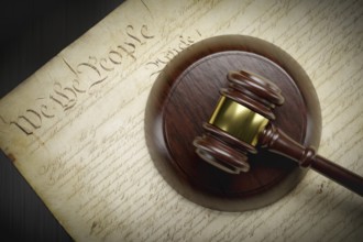 United states constitution and gavel resting on table