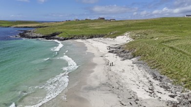 An idyllic coastal landscape with a sandy beach and green meadow under a blue sky, Meal Beach,